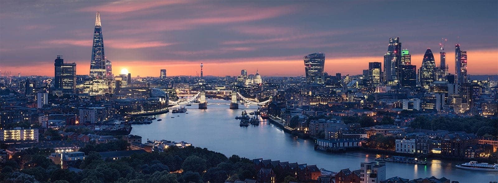 London skyline at dusk along the River Thames